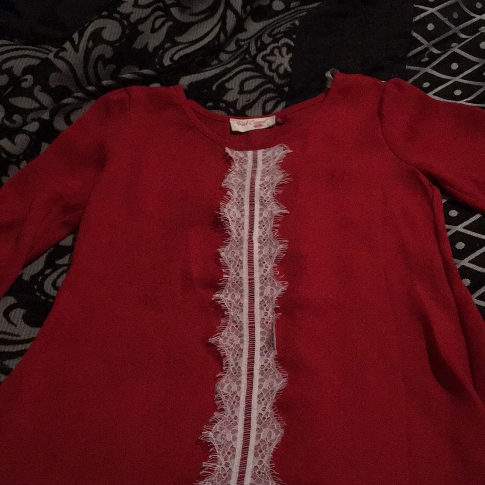 A dark red shirt with white lace down the middle.